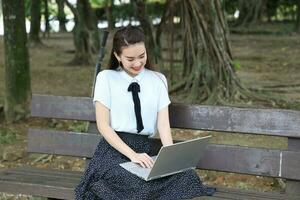 Young asian chinese woman outdoor park campus book photo