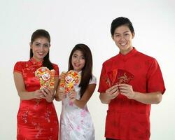 South East Asian young Malay Chinese Indian man woman wearing traditional chinse cheongsam dress on white background shop exchange gift orange greetings share racial unity harmony hand fan photo