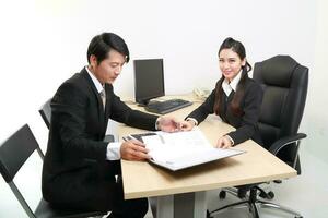 Young Asian man woman wearing business office suit chair table computer white background photo