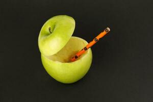 Healthy Green Cut Apple recyclable paper straw juice drink idea concept on black background photo