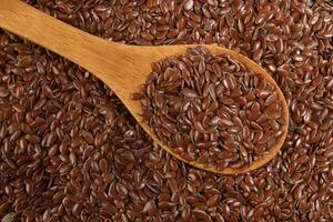 Flex seed flaxseed closeup wooden spoon laid on top view photo