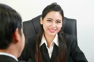 Young Asian man woman wearing business office suit chair table computer white background photo