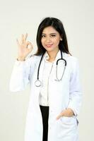 Young Asian female doctor wearing apron stethoscope ok finger sign photo