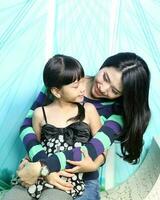 South East Asian young father mother daughter  parent girl child activity indoor photo