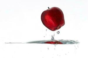 Red Apple splash wave ripple in water upside down white background photo