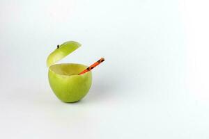 Healthy Green Cut Apple recyclable paper straw juice drink idea concept on white background photo