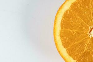 Ripe juicy orange half cut closeup on white background photo