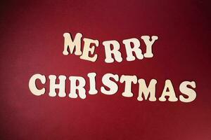 Merry Christmas sign on red paper background color wooden alphabet photo