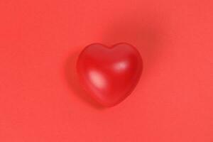 Hart Love shape plastic rubber object red background photo