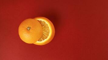 Healthy Orange Cut floating top slice juice drink idea concept on red background photo