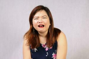 Young attractive southeast Asian woman posing facial expression cry sad photo