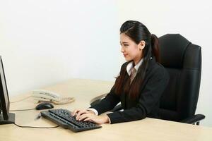 Young Asian man woman wearing business office suit chair table computer white background photo