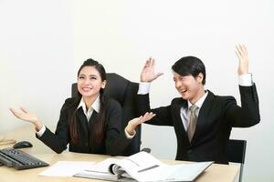 Young Asian man woman wearing business office suit chair table computer white background photo