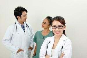 Young asian malay chinese male female doctor on white background smile confident looking at camera photo