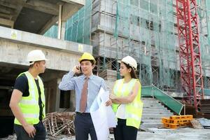 South East Asian young Malay Chinese man woman wearing safely helmet construction site work photo