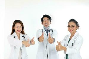 Asian Malay Chinese male female three doctors thumbs up towards camera on white background photo