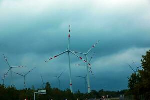 Wind farm or windmill in cloudy weather in Austria in Europe, allows you to get clean energy. It's sustainable, renewable energy for the environment photo