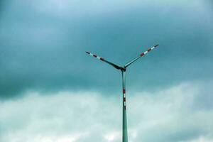 Wind farm or windmill in cloudy weather in Austria in Europe, allows you to get clean energy. It's sustainable, renewable energy for the environment photo