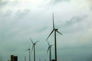 Wind farm or windmill in cloudy weather in Austria in Europe, allows you to get clean energy. It's sustainable, renewable energy for the environment photo