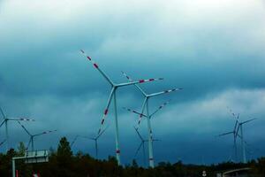 Wind farm or windmill in cloudy weather in Austria in Europe, allows you to get clean energy. It's sustainable, renewable energy for the environment photo