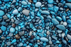 background made up of blue pebbles arranged in a mosaic pattern. The pebbles vary in shades of blue and are rounded and smooth in texture, made with photo