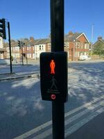 Pedestrian traffic light control button at crosswalk showcasing red person for safe road crossing. Pedestrian safety in the big city of London. Crosswalk button for pedestrian. photo