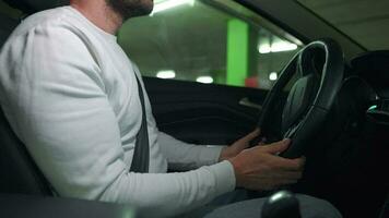 Man driving in innovative automated car using self-parking autopilot for parking on parking lot video