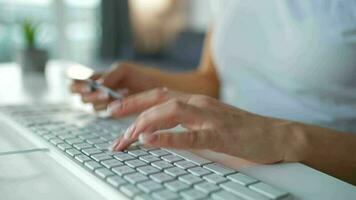 Female hands typing credit card number on computer keyboard. Woman making online purchase. Online payment service. Close up of woman hands hold credit card and using computer for online shopping video