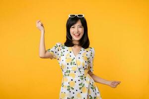 Portrait cheerful young asian woman happy smile dressing springtime female style fashion isolated on yellow background. attractive pretty model girl posing emotion summertime concept. photo