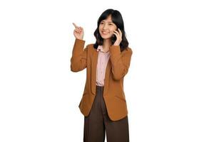 Young business asian woman listening to mobile phone and pointing finger to free copy space isolated on white background photo