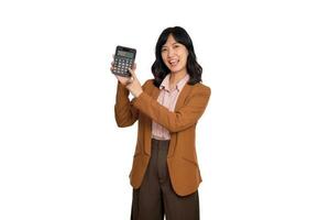 Tax day concept. Asian woman confident smiling holding calculator and finger point device, Portrait happy Asian female isolated on white background, Account and finance counting income photo