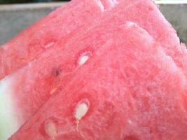 Fresh ripe sliced watermelon on wooden rustic background photo