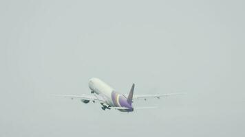 PHUKET, THAILAND DECEMBER 2, 2016 - Thai Airways Boeing 777 HS TKD departure from Phuket International airport, rainy weather video