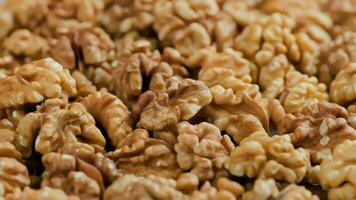 looped spinning walnuts without the shell close-up full frame background video