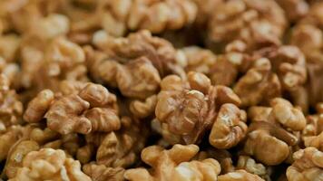 looped spinning walnuts without the shell close-up full frame background video