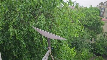 Starlink satellite dish, an internet constellation operated by SpaceX, is installed on the wall of an apartment building. video