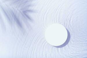 Podium or pedestal with water ripple and palm shadow flat lay, top view. Summer cosmetic template, mock up photo