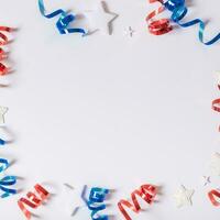 USA Independence day concept. Red and blue spirals and white stars elements of USA flag top view, flat lay on blue background photo