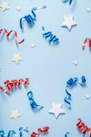 USA Independence day concept. Red and blue spirals and white stars elements of USA flag top view, flat lay on blue background photo