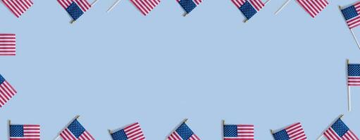 USA flags top view, flat lay on blue background with copy space. Independence day banner concept photo