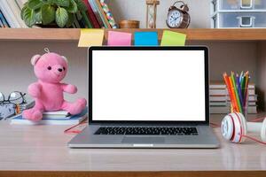 Laptop on desktop with blank screen in children's room. Kid education mockup, template photo