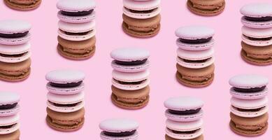 Pattern made from pastry macarons on a pink background. Sweet food background photo