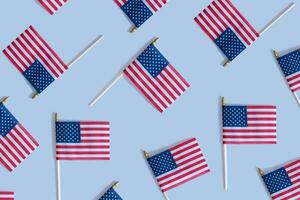 Pattern from USA flags top view, flat lay on blue background. Independence day concept. photo