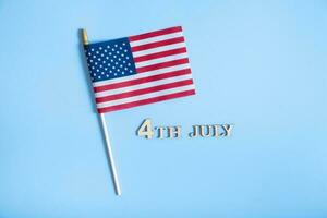 Independence day text with USA flags top view, flat lay on white background photo