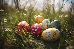 Colorful easter eggs on green grass with flowers in the background. . photo