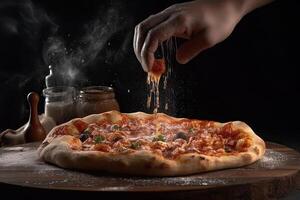 Pizza with tomato, mozzarella and olives on black background, In a close-up view, the hands of a chef skillfully assemble a delicious photo