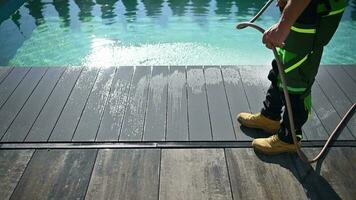 Man Cleaning Poolside Deck Using Garden Hose video