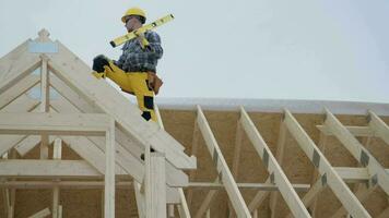 Worker on the Newly Developed Wooden House Frame video