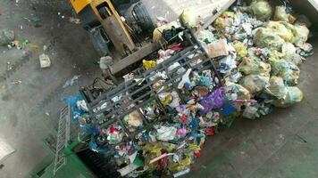 Aerial View of Trash Sorting Facility Garbage Crusher Being Loaded by a Bulldozer video