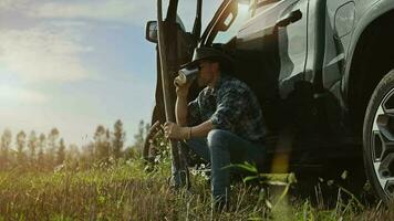 Cowboy Enjoying Late Afternoon Drinking Fresh Coffee Next to His Pickup Truck video